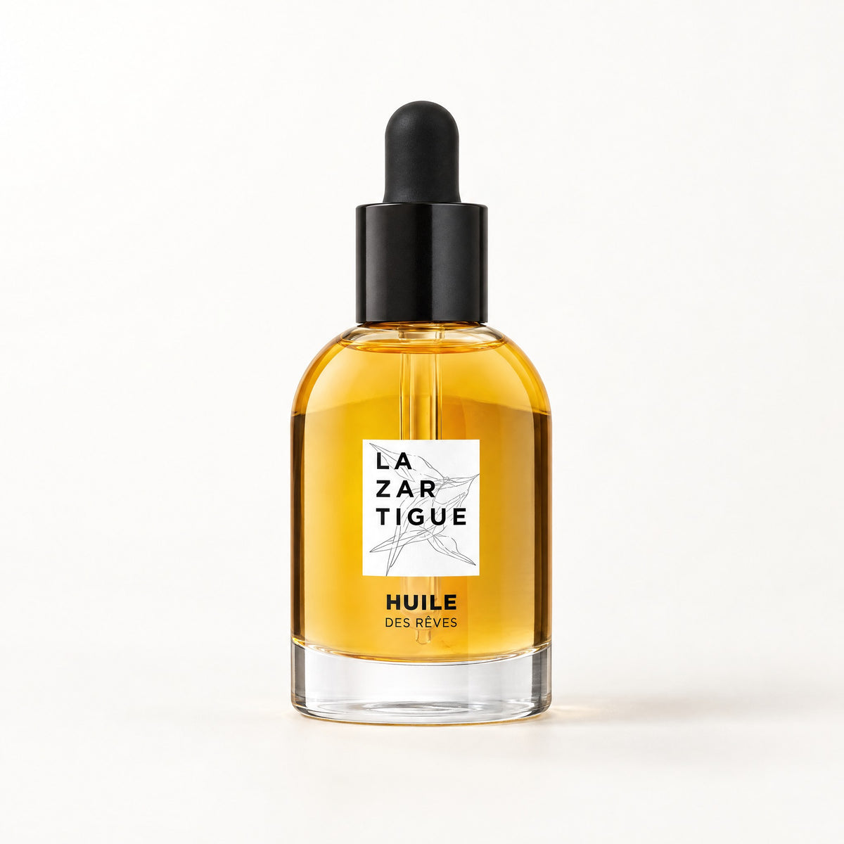 Frasco de vidrio con aceite ámbar y gotero negro, etiqueta blanca, Huile Des Rêves 50 ml La Zartigue